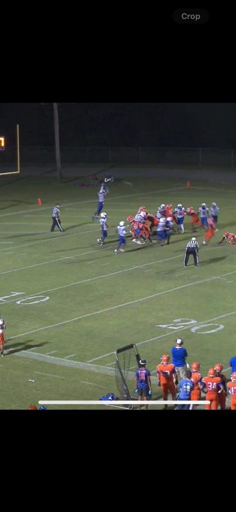The Wildwood Wildcats lined up during a night football game.